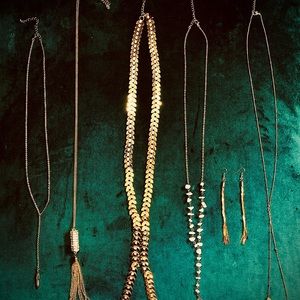 Golden pendants with crystal or stone. Golden earrings. Very shiny.